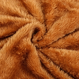 Macro shot of plush faux fur lining in caramel brown for winter hooded jacket