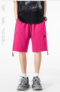 Detail of rose red cargo shorts with adjustable drawstring waist and side zippers