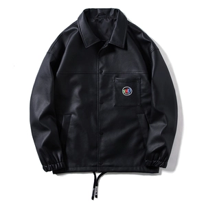 Detail of black faux leather jacket showing classic lapel collar and round logo on chest pocket