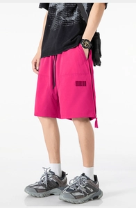 Detail of rose red cargo shorts with drawstring waist and unique barcode graphic print