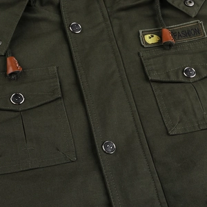 Detail of military green cargo jacket featuring breast pockets and fashion logo patch