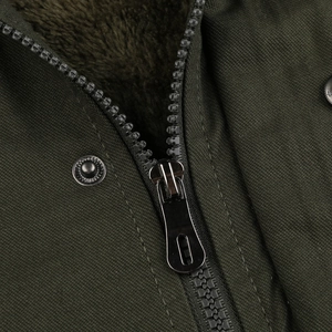 Close-up of military green jacket with durable metal zipper and warm brown fleece lining