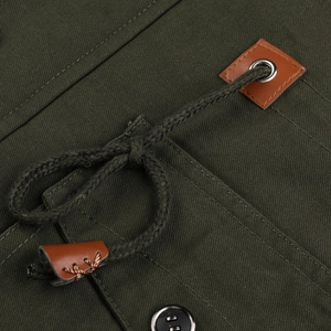 Close-up of olive green cargo jacket with premium leather patches and metal eyelets