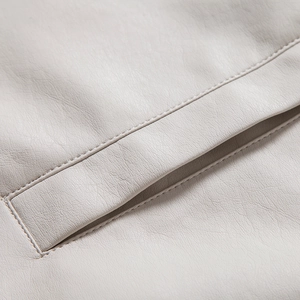 Detail shot of men leather jacket pocket showing fine stitching and beige lychee texture