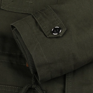 Detail of army green military jacket featuring windproof ribbed cuffs and button straps