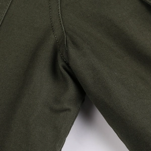 Macro shot of double-needle stitching on olive green cargo jacket durable seams