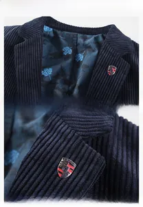 Detail of navy blue corduroy blazer showing maple leaf lining and metal crest pin