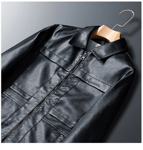 Detailed close-up of premium black PU leather jacket with fine embroidery and zip collar
