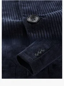 Detail of dark blue corduroy blazer showing black resin buttons and triple-button cuffs