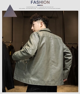 Detail of gray-green slim fit PU leather jacket featuring zippered cuffs and stitching