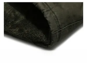 Close-up detail of the jacket hem featuring thick dark grey fleece lining and green fabric