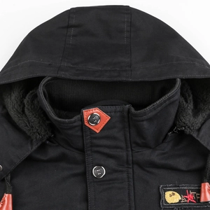Close-up of black hooded jacket featuring warm fleece lining and leather neck detail