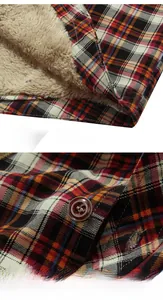 Detail view of winter plaid shirt showing warm beige sherpa lining and hem stitching