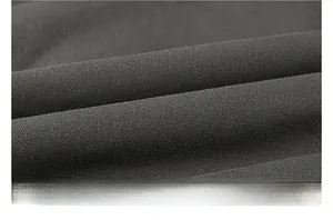 Macro shot of dark grey washed cotton fabric with soft brushed texture and twill weave