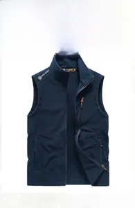 Detail of navy blue fleece vest showing a zippered chest pocket and white logo embroidery