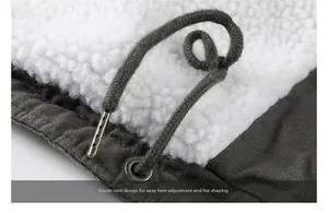 Detail of adjustable drawstring hem with white lamb wool lining on a gray winter parka