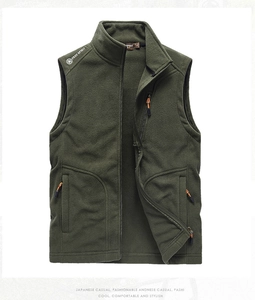 Detail of army green fleece vest showing stand collar, zipper pockets and fabric texture