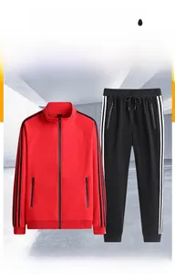 Detail of red stand-collar jacket and black drawstring pants with sporty side stripes