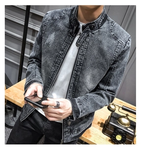 Close-up of vintage black denim jacket showing snow wash texture and standing collar detail