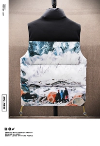 Detail of winter puffer vest featuring a snow mountain landscape print and stand collar