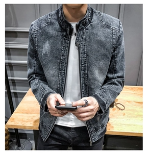 Detailed close-up of distressed denim jacket fabric with stand collar and metal zipper