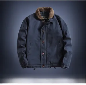 Close-up of navy blue winter jacket featuring brown faux shearling collar and ARMY print