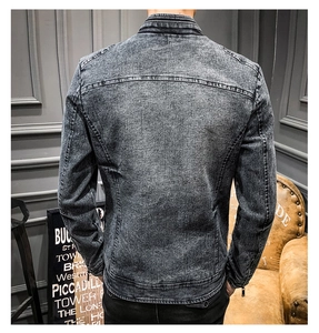 Detail of acid wash gray denim jacket showing back seam construction and zipper cuff