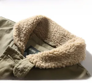 Close-up of military green tooling jacket collar with thick beige fleece lining