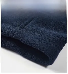 Detail of navy fleece vest hem showing premium textured fabric and high-quality stitching