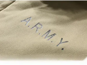 Close-up of khaki canvas fabric with vintage A.R.M.Y. letter print on army winter jacket