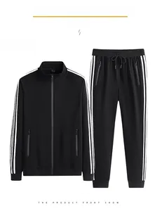 Detail of black sports jacket and pants with white side stripes and zip pockets