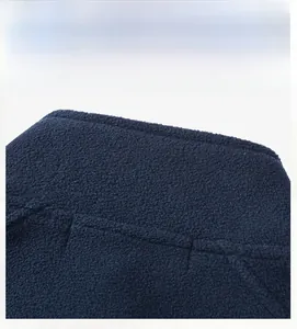 Close-up of high-quality navy polar fleece fabric with neat stitching on the back