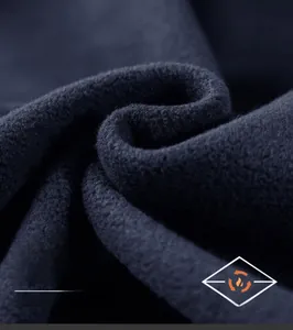 Detailed macro view of high-density navy fleece fabric with heat-trapping texture