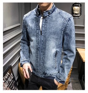 Detail of slim-fit men's vintage light blue acid wash denim jacket with zipper pockets