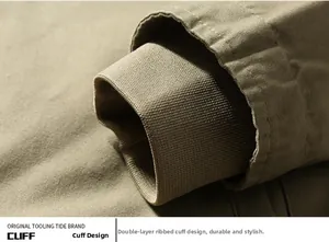 Detail of khaki workwear jacket showing double-layered ribbed windproof cuffs texture