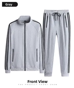 Detailed view of gray cotton tracksuit featuring three black side stripes and metal zippers