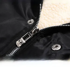 Detail of metal zipper and premium white faux fleece lining on black winter jacket