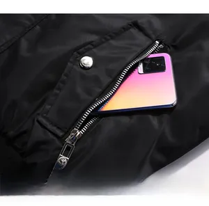 Close-up of a zippered side pocket on a black pilot jacket showing secure storage capacity