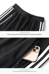 Detail of elastic waist with drawstring and side zipper pocket holding a smartphone