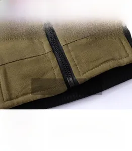 Detailed view of military green cotton canvas jacket with ribbed hem and reinforced stitching
