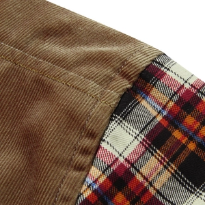 Close-up of winter brown corduroy and red plaid flannel patchwork on thick shirt
