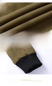 Close-up of military green canvas fabric texture and black ribbed windproof cuffs on jacket