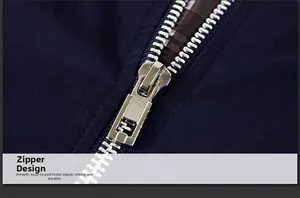 Close-up of a silver metal zipper on a navy jacket with brown checkered lining detail