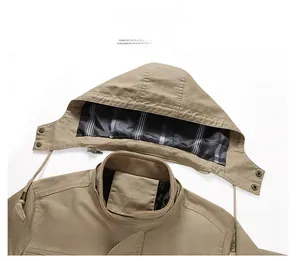 Macro detail of men khaki cotton jacket featuring a detachable hood and plaid lining