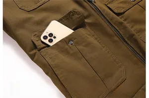 Detail of cargo jacket large pocket with metal rivets and phone storage capacity