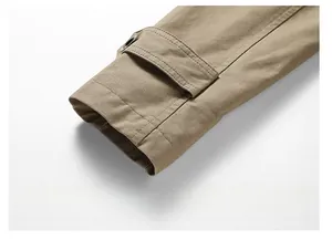 Detail of adjustable khaki cotton jacket cuff with dark button and neat stitching