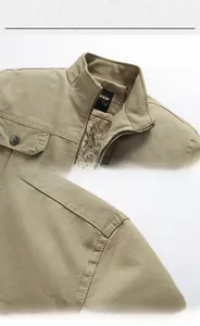 Detail of khaki men's work jacket with warm faux fur lining and stand collar design