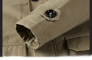 Detail of khaki jacket cuff featuring double-row contrast stitching and button strap