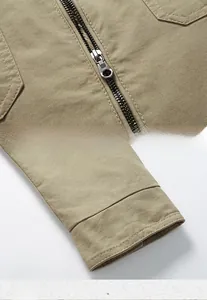 Detail of durable metal zipper and flat cuff stitching on khaki canvas casual jacket
