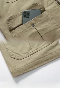 Detail of khaki canvas jacket showing buttoned pocket and durable double-stitched hem finish